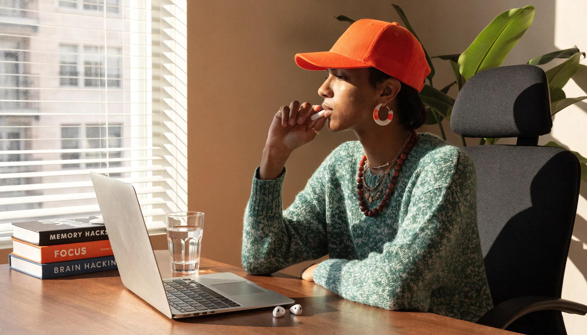 A person using sublingual nootropics under natural light, symbolizing cognitive enhancement and focus.