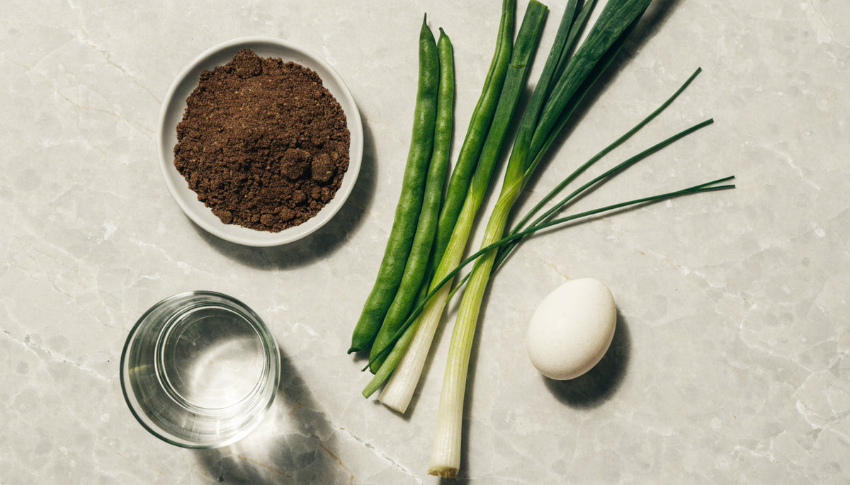Fibre, vegetables, egg and water arranged as a satiety nutrition flat lay