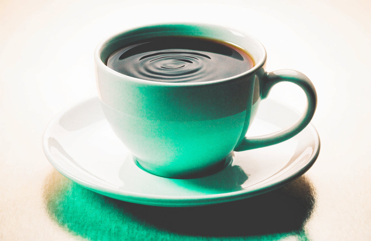 A coffee cup with rippling surface and motion blur, conveying caffeine jitters