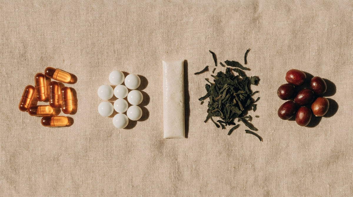 Flat lay comparing capsules, mints, chewing gum, green tea leaves and coffee cherries