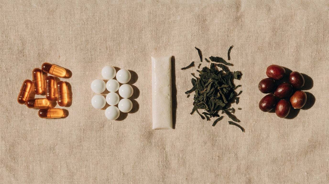 Flat lay comparing capsules, mints, chewing gum, green tea leaves and coffee cherries
