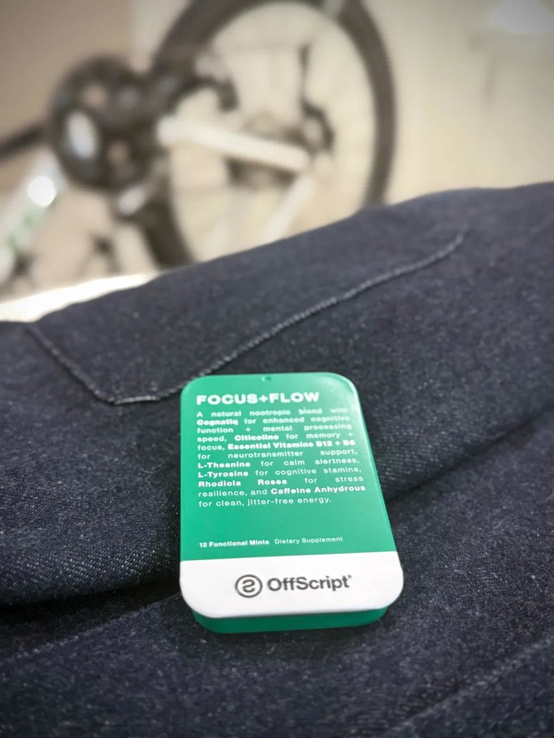FOCUS+FLOW tin on a jacket, bike in the background
