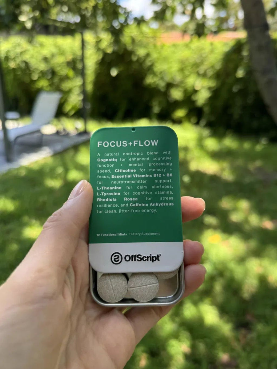 Customer holding an open FOCUS+FLOW tin in a sunny backyard